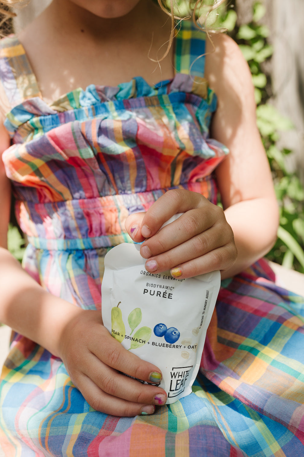 Toddler Enjoying Organic Regeneratively Farmed Pear + Spinach + Blueberry + Oat Baby Food Pouch | White Leaf Provisions